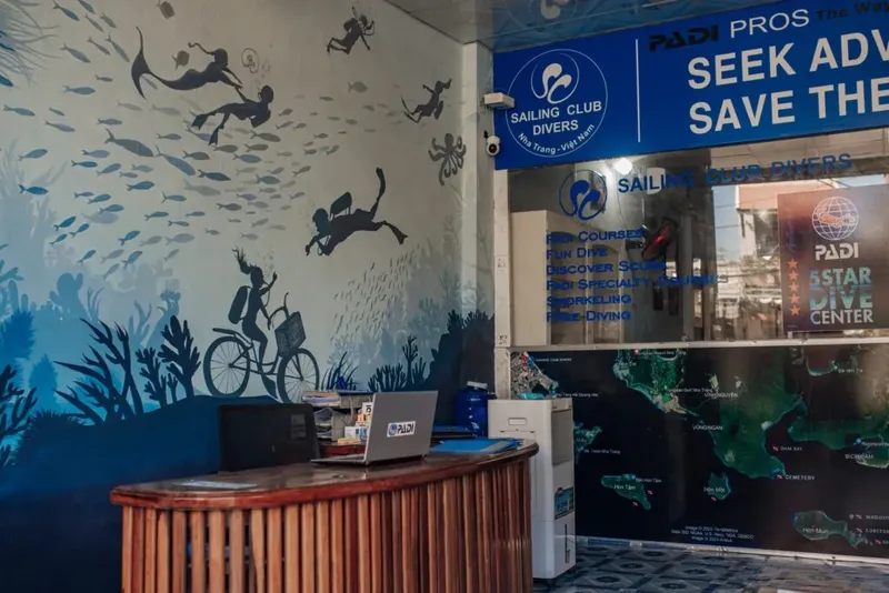 Comptoir d'accueil d'un centre de plongée avec décorations marines et logos