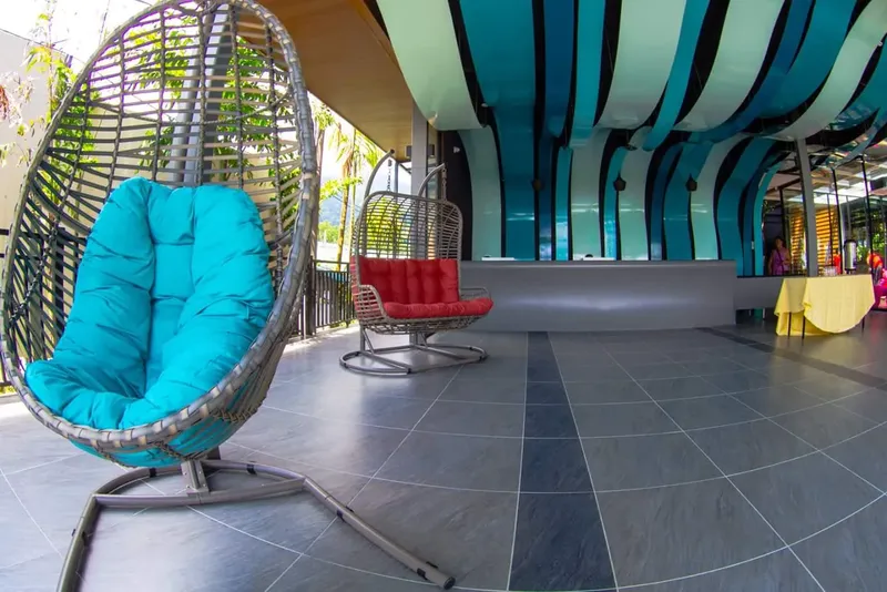 Espace détente avec fauteuils suspendus et sol carrelé moderne