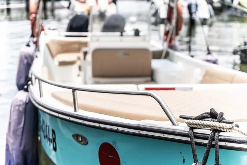 Bateau de plongée bleu et beige amarré à quai sur l'eau