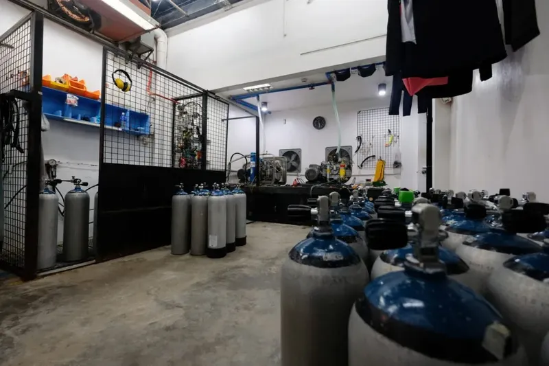 Rangement de nombreuses bouteilles de plongée dans un local spacieux