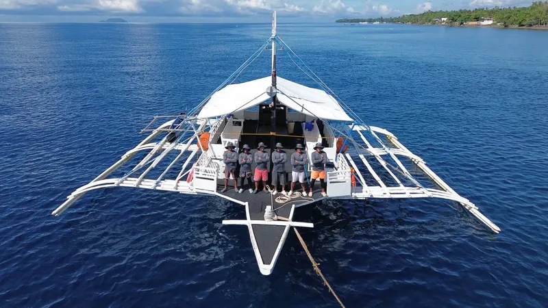 Groupe de personnes debout sur la proue d'un bateau en mer