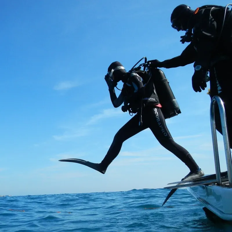 Plongeur s'apprête à sauter depuis un bateau en pleine mer