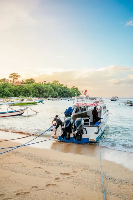 Bateau de plongée échoué sur une plage de sable au lever du soleil