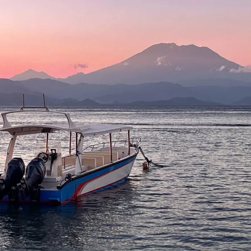 Bateau de plongée amarré sur une mer calme au coucher du soleil