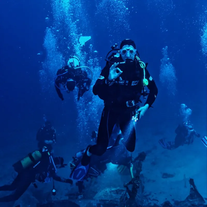 Plongeurs en immersion profonde, communication gestuelle, ambiance bleue