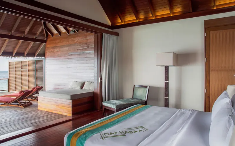 Chambre d'hôtel luxueuse avec vue sur l'océan et décoration boisée