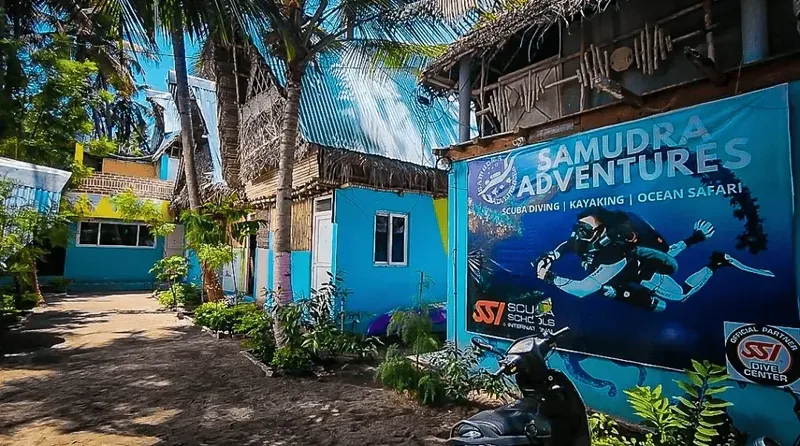 Façade bleue d'un centre de plongée avec une illustration de plongeurs