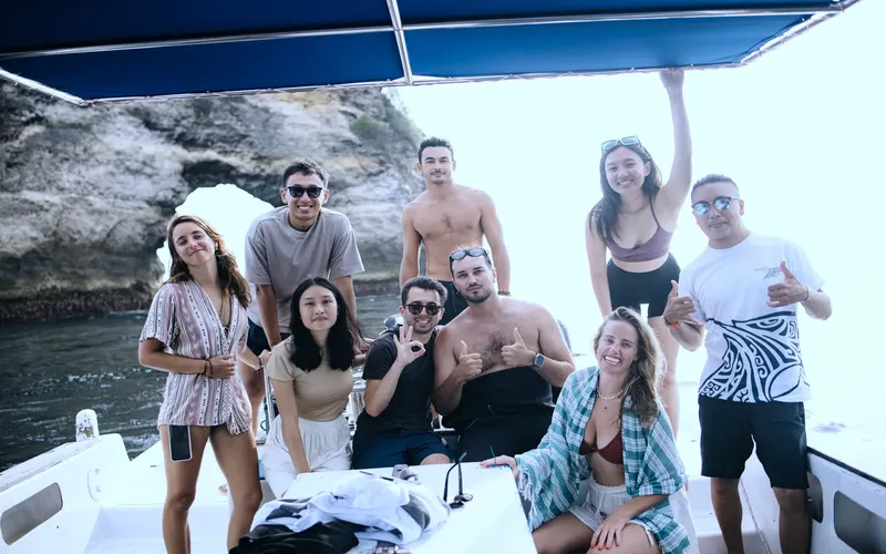 Groupe de personnes souriantes à bord d'un bateau en mer