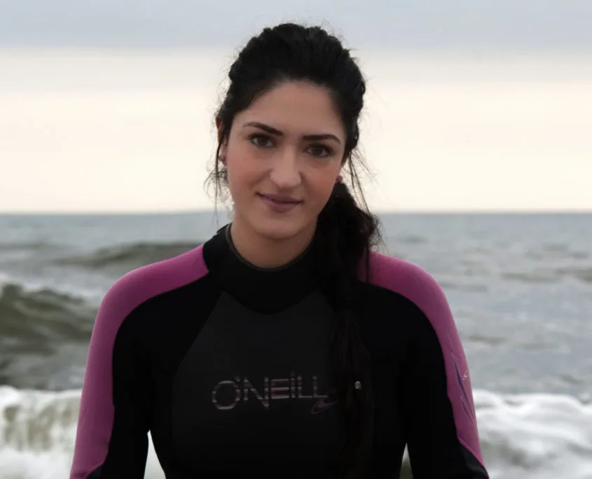Jeune femme souriante en combinaison de plongée sur fond marin