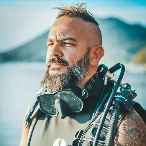 Plongeur barbu regardant au loin avec son équipement complet