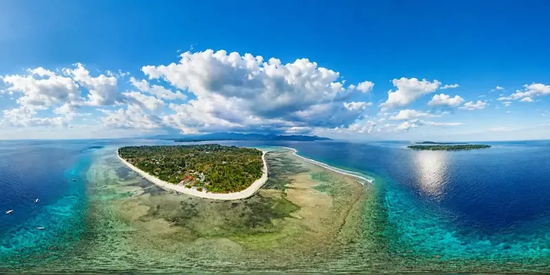 Île tropicale entourée d'eaux turquoise et de récifs coralliens
