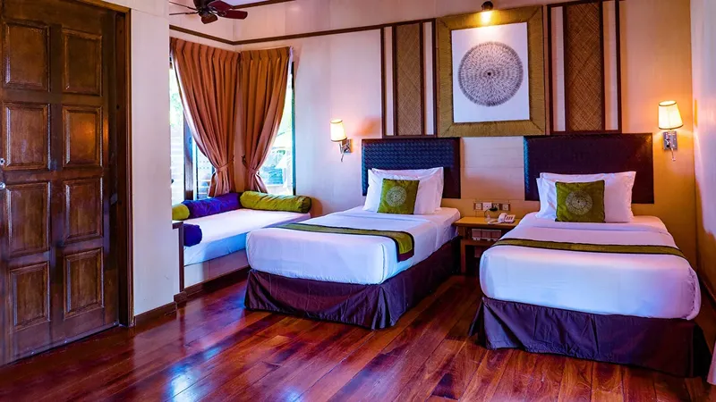 Chambre d'hôtel avec deux lits, décoration colorée et vue sur l'extérieur