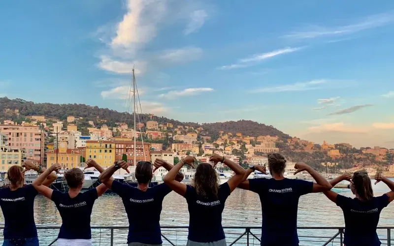 Groupe de personnes faisant un signe de force devant la mer
