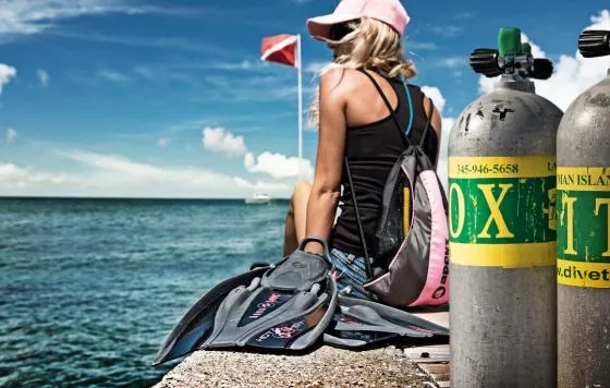 Plongeuse préparant son équipement au bord de la mer ensoleillée