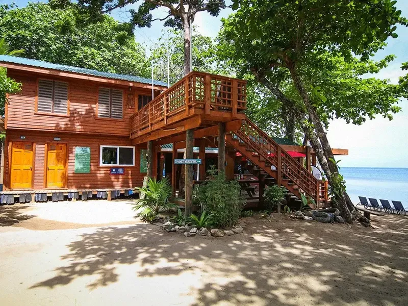 Bâtiment en bois surélevé face à la mer et à la plage