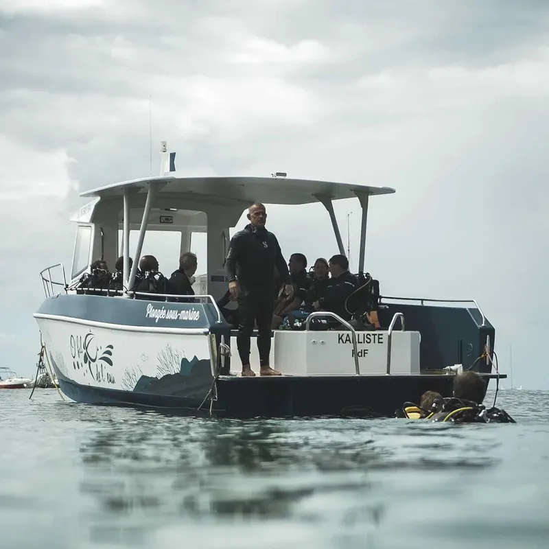 Bateau de plongée avec des plongeurs équipés prêts à partir en mer