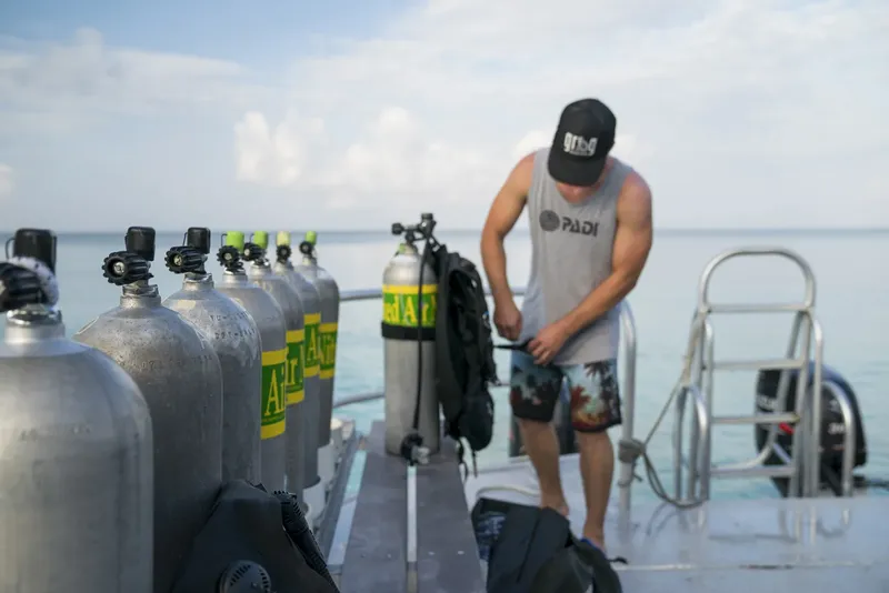 Homme préparant l'équipement de plongée sur un bateau en mer