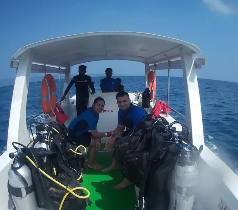 Plongeurs souriants sur un bateau de plongée en mer, équipés