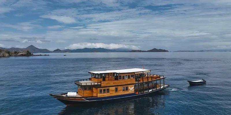 Grand bateau de croisière en mer, îles au loin, ciel nuageux