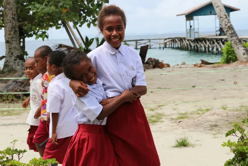 Groupe d'enfants souriants sur une plage tropicale ensoleillée