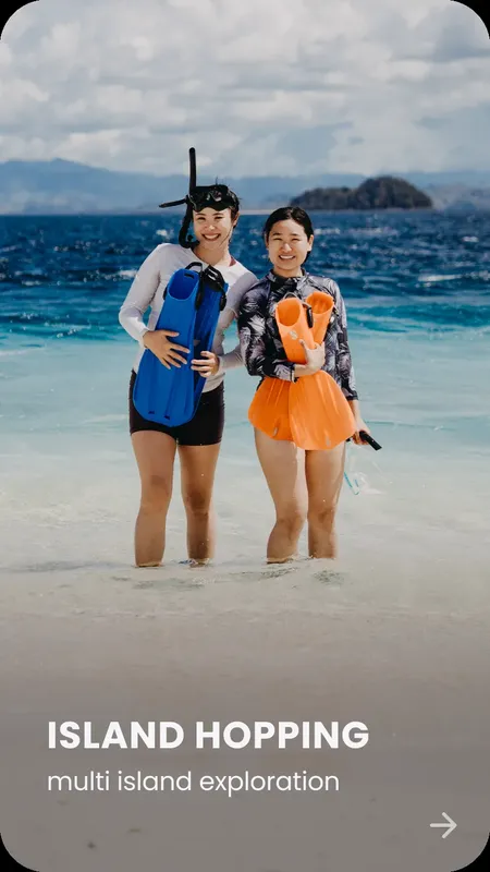 Deux femmes souriantes sur une plage avec du matériel de snorkeling