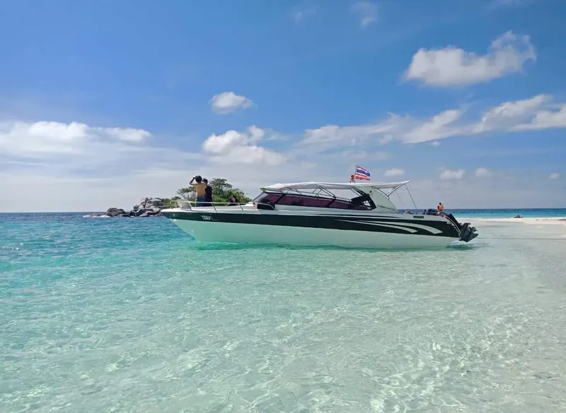 Bateau rapide échoué sur une plage de sable blanc turquoise