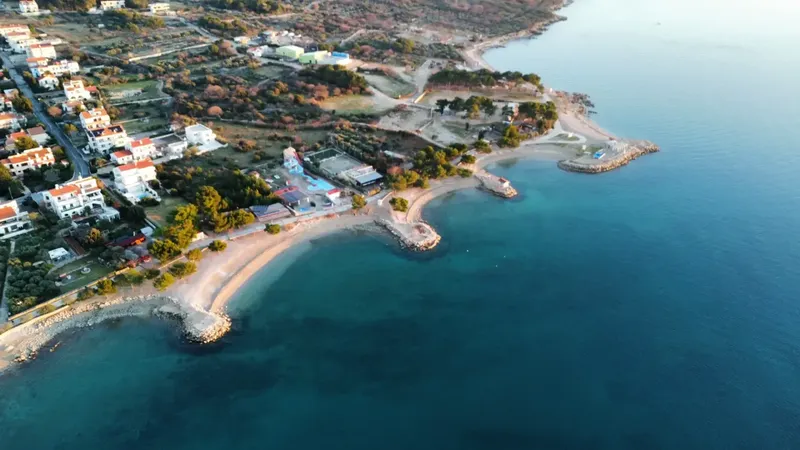 Vue aérienne d'une côte rocheuse avec des bâtiments et la mer