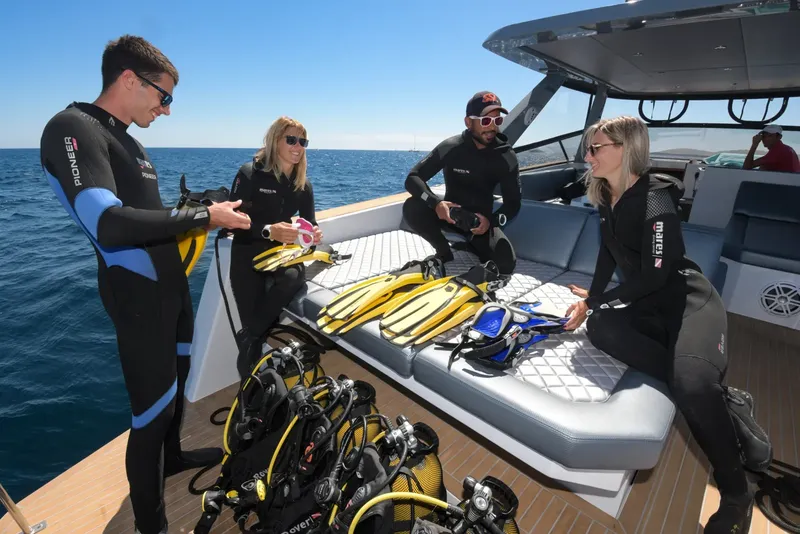 Plongeurs équipés sur un bateau de plongée en mer ensoleillée
