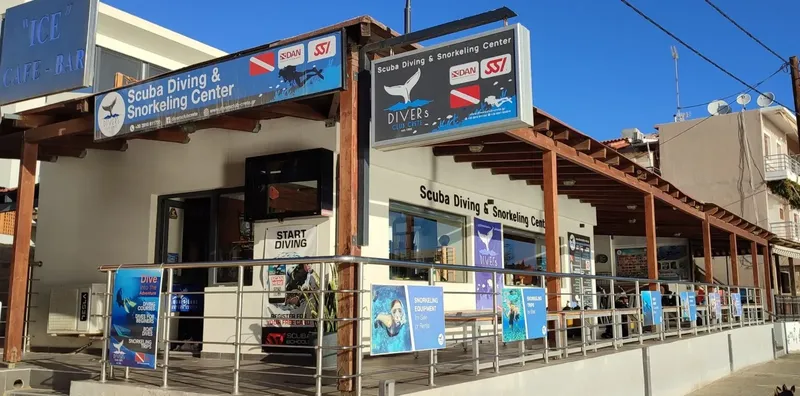 Façade d'un centre de plongée avec enseigne, matériel et affiches