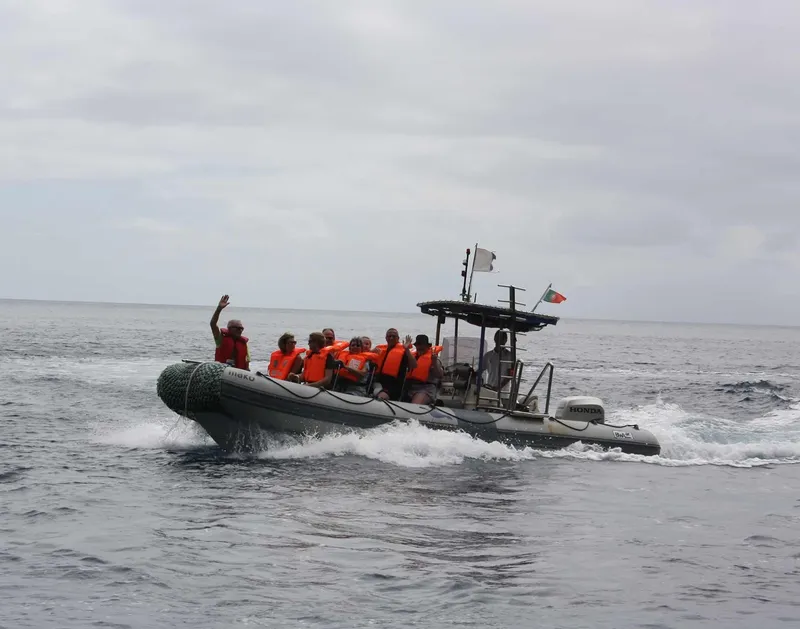 Embarcation semi-rigide en mer avec plusieurs personnes souriantes