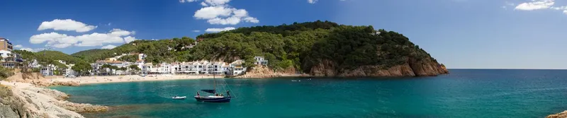 Vue panoramique d'une crique avec des bateaux et une végétation luxuriante