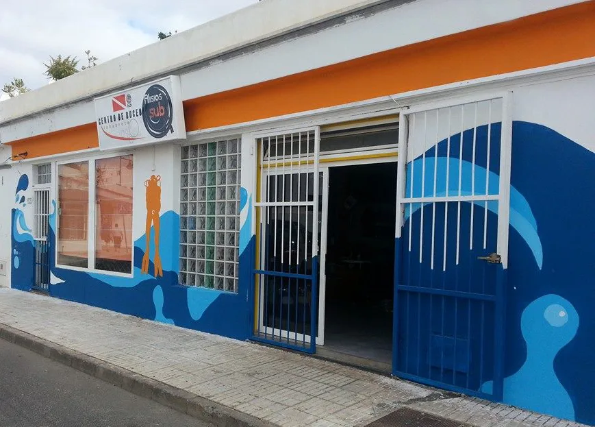Façade d'un centre de plongée avec des peintures murales marines colorées