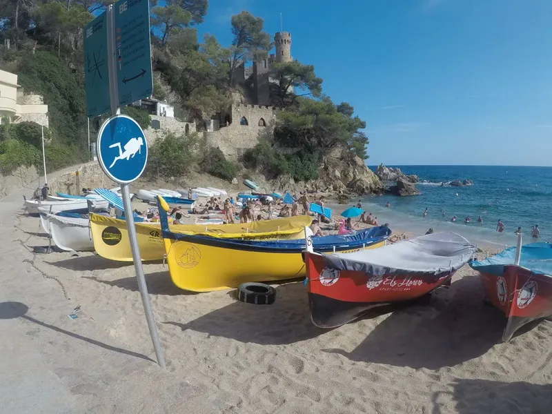 Plage ensoleillée avec des bateaux colorés et des personnes se relaxant