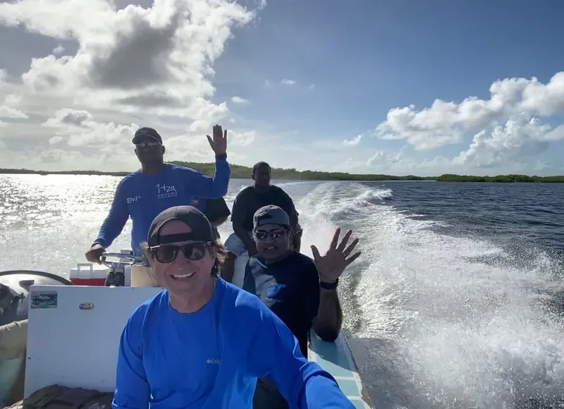 Quatre personnes souriantes sur un bateau rapide en pleine navigation