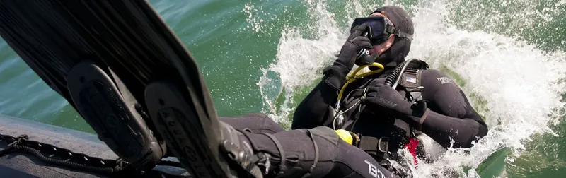 Plongeur s'équipant sur un bateau en mouvement, vue rapprochée
