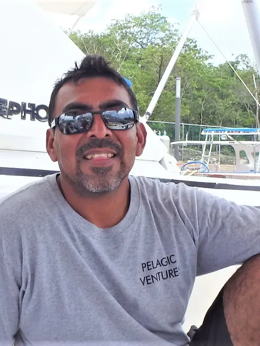 Homme souriant portant des lunettes de soleil sur un bateau