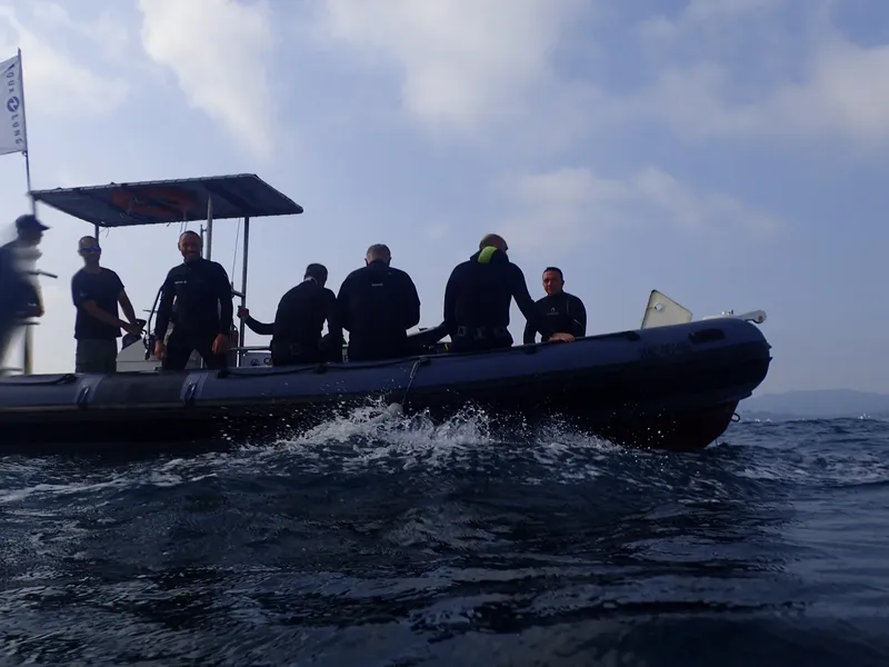 Groupe de plongeurs à bord d'un bateau semi-rigide en mer
