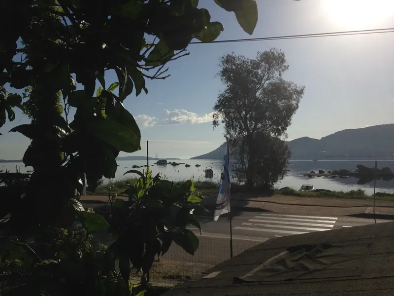Vue sur la mer, bateaux amarrés, passage piéton et drapeau flottant