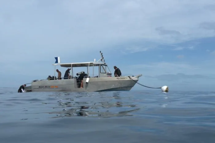 Bateau de plongée avec des plongeurs préparant une sortie en mer
