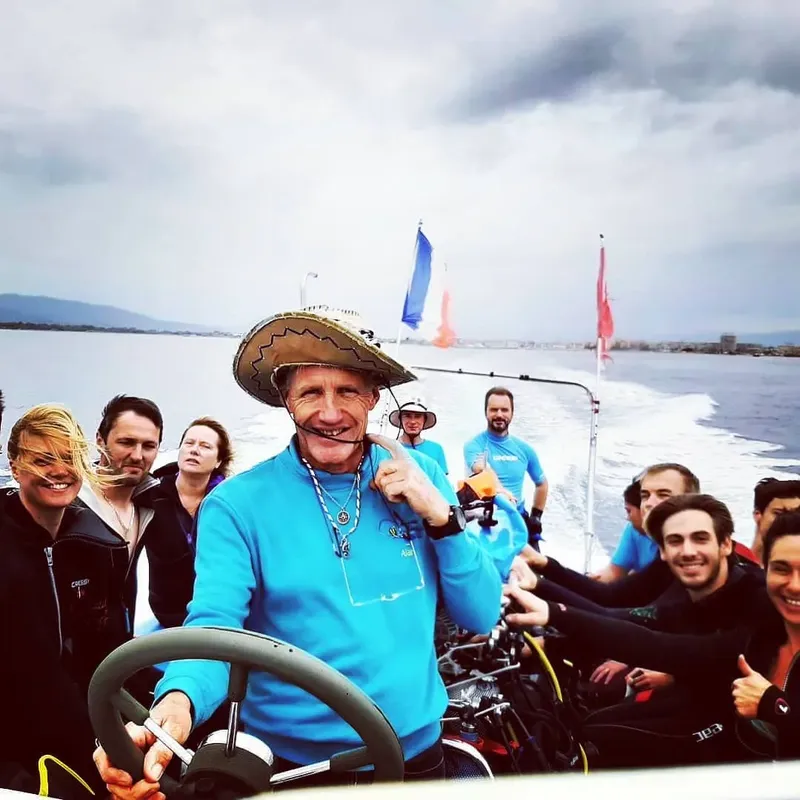 Groupe de personnes souriantes sur un bateau en mer, ambiance joyeuse