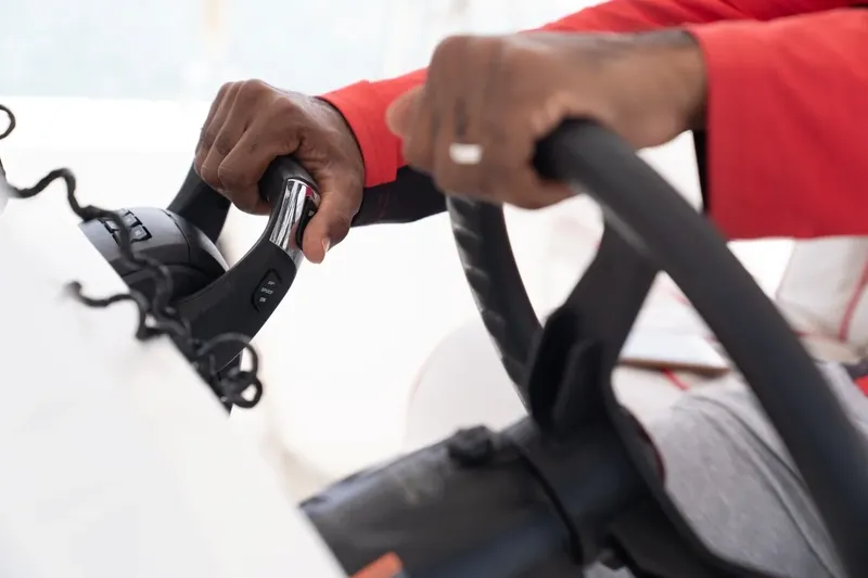 Mains manipulant un équipement de plongée sur un bateau blanc