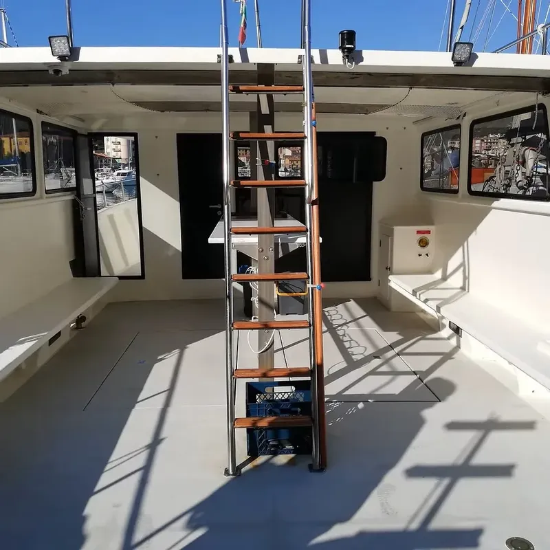 Intérieur d'un bateau de plongée avec un escalier central en bois