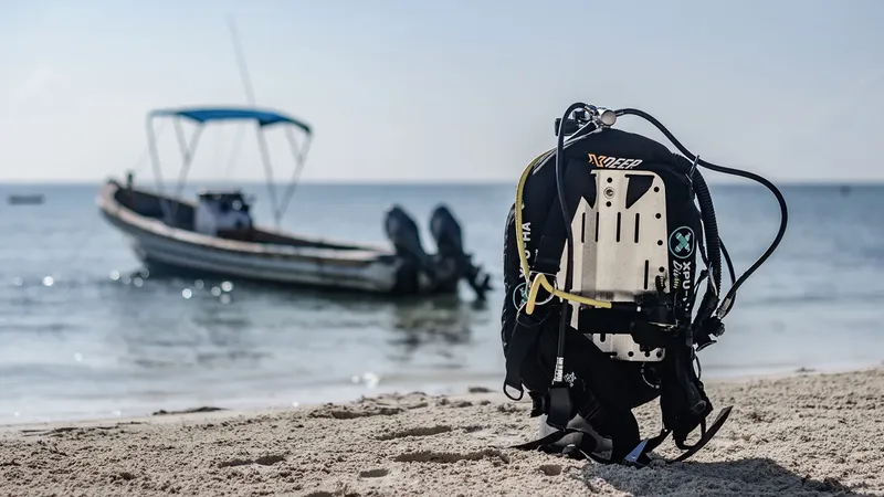 Equipement de plongée sur une plage avec un bateau en arrière-plan