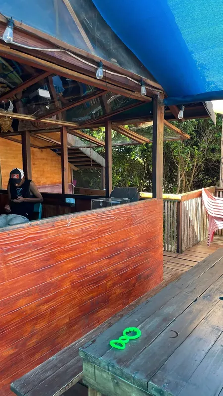 Terrasse couverte en bois avec comptoir et personne assise à l'intérieur