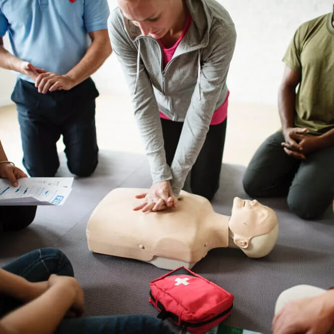 Formation aux premiers secours avec un mannequin et des participants