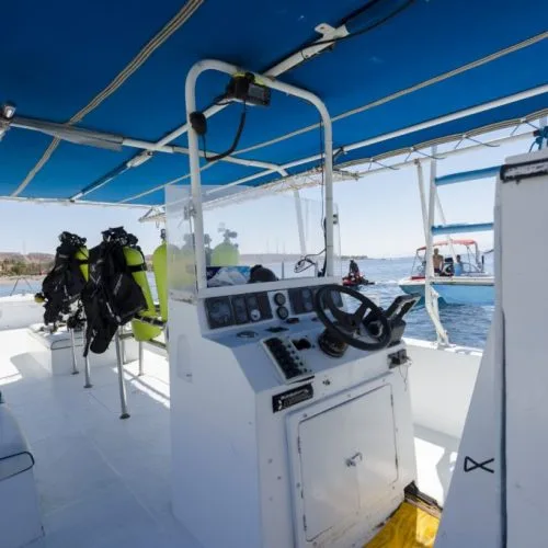 Intérieur d'un bateau de plongée avec des bouteilles et le poste de pilotage