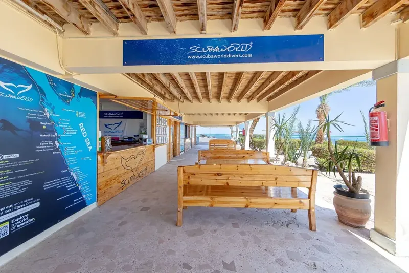 Intérieur d'un centre de plongée avec comptoir d'accueil et rangées de bancs