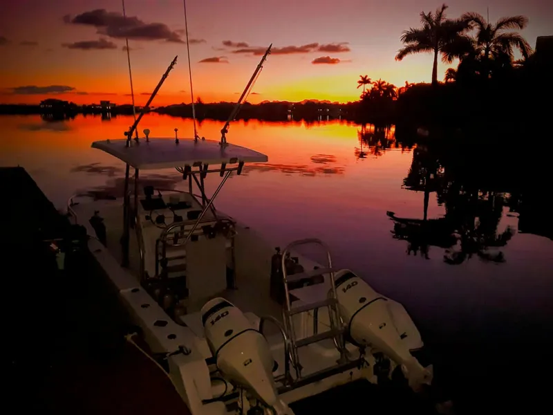 Bateau de pêche au coucher du soleil sur une eau calme