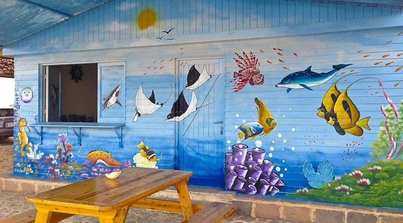 Façade d'un bâtiment décorée d'une fresque marine colorée et joyeuse