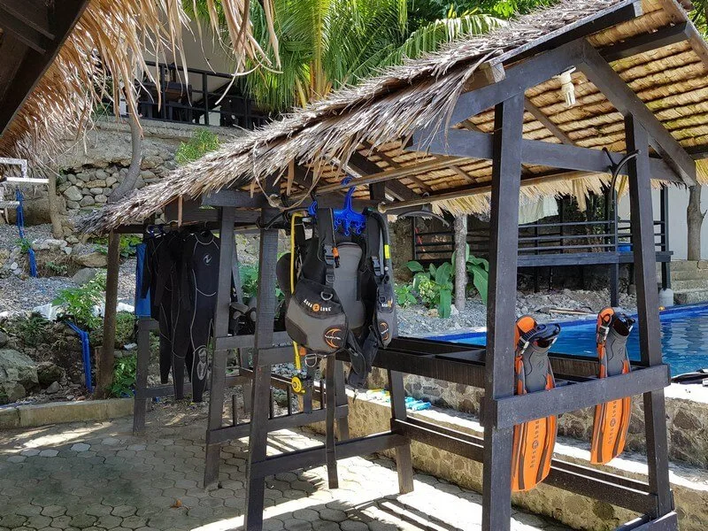 Equipement de plongée suspendu sous un abri en chaume ensoleillé